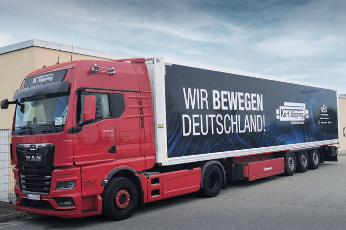 Ein roter LKW mit der Aufschrift "Wir bewegen Deutschland".